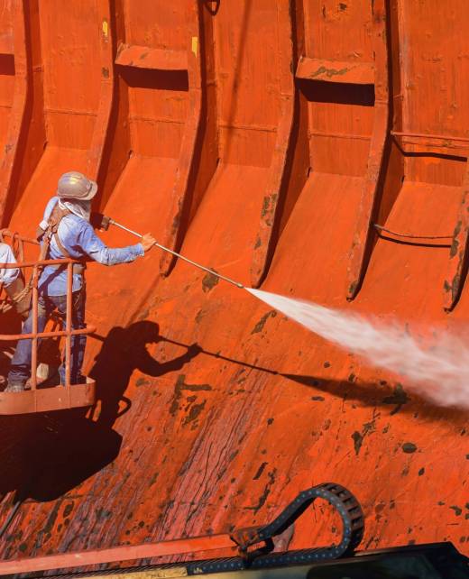 shutterstock_1524090242 Two workers perform cargo hold cleaning with high pressure washer